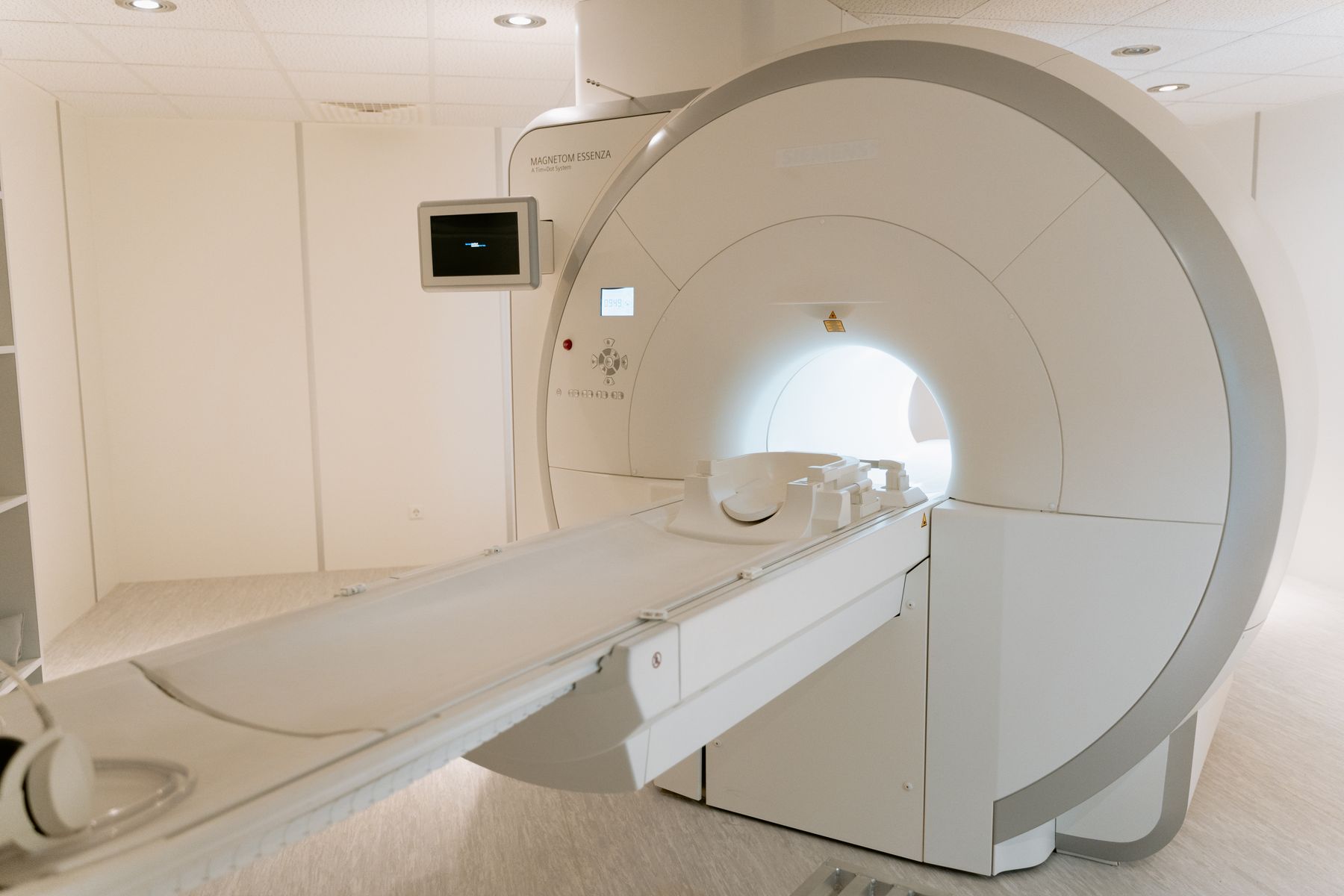 A cylindrical brain imaging scanner in a scanning room